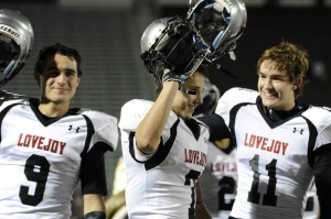 Chochy Luce, Grant Jarvis, and Adam McDaniel, raise their helmets during the Alma Mater.