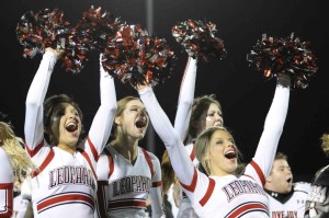 Cheerleaders celebrate after the Alma Mater.