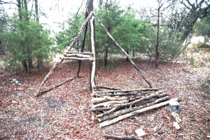 Senior Zach Fisher's art installation in the woods resembles a teepee.
