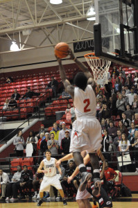 Senior Joesph Reed dunks the ball to score two points in the varsity men's Senior Night.