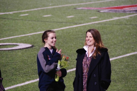 Student Ashley Fahey and the teacher she elected, Amy Paige, share a laugh on the field to celebrate their accomplishments.