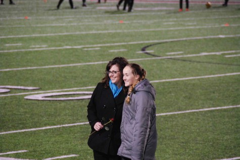 eacher Amanda Glorioso and her student share a moment on the field after being chosen to show all the great times they’ve had together as teacher-student. 