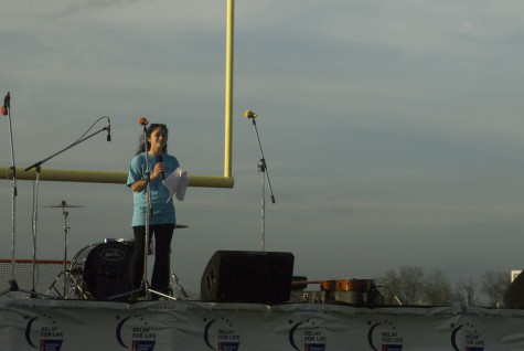 Senior Liz Schasel, Event Chair of the Relay for Life Committee, speaks during the Opening Ceremony on Friday, April 11, 2014.