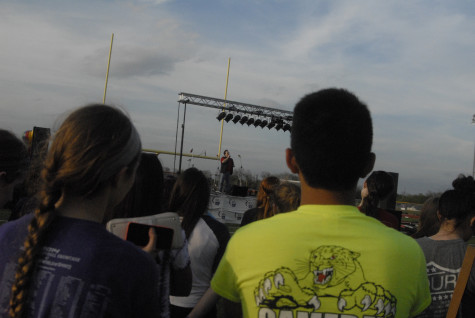 Students watch teacher Andrew Stallings speak at the Opening Ceremony about his battle with cancer on Friday, April 11, 2014.