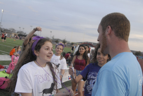 Freshman, Carolyn Murad tries to sell necklaces to Senior Colton Alleman on Friday, April 11, 2014.