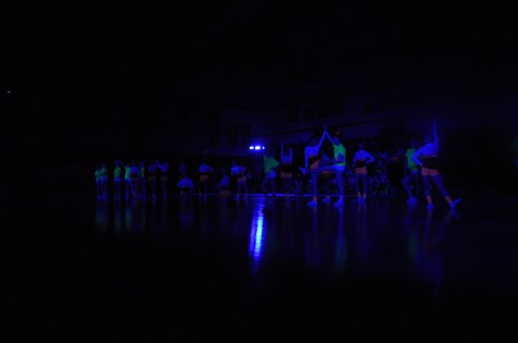 Cheerleaders perform their routine during the Black Light Pep Rally Friday, April 11, 2014.