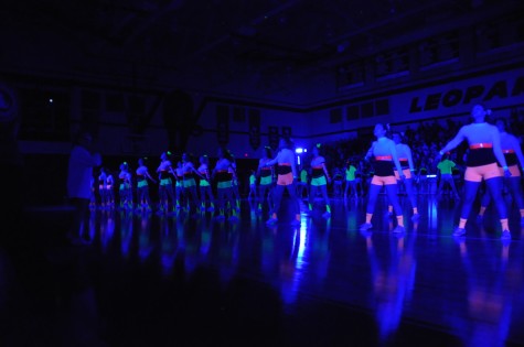 Cheerleaders perform the cowbell dance during the Black Light Pep Rally Friday, April 11, 2014.